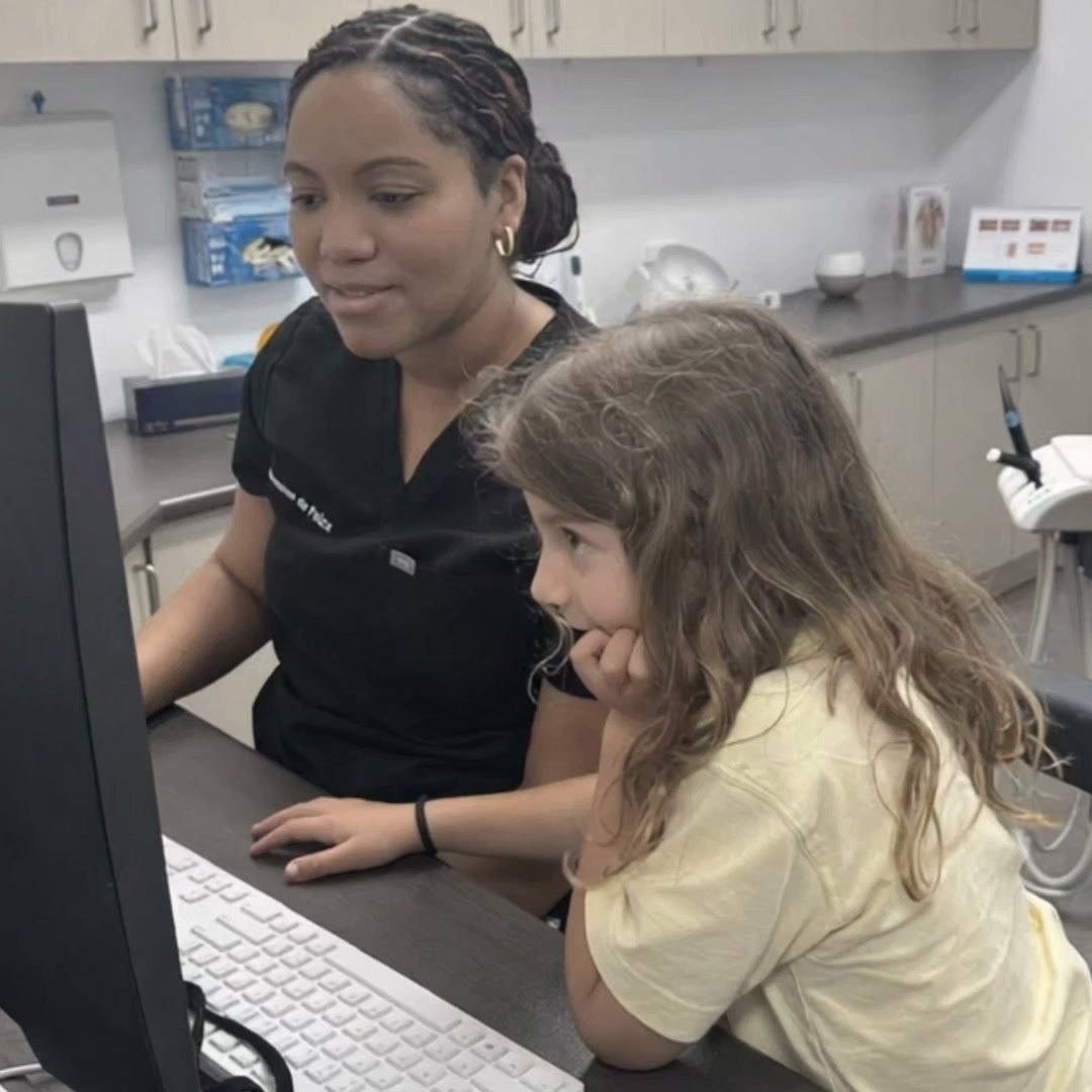 Dr Jeannae showing a young patient her x-rays